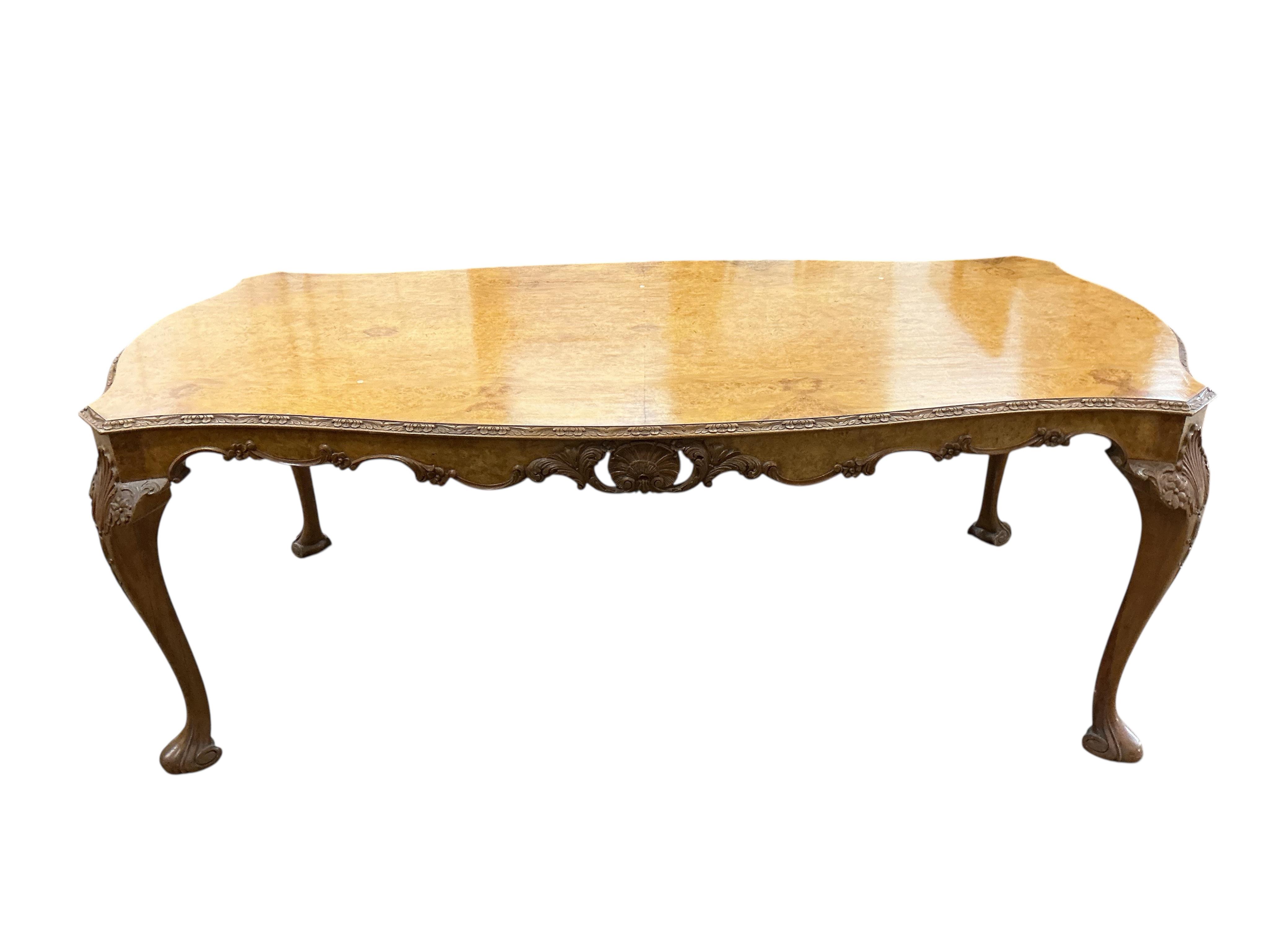 A Queen Anne Revival rectangular walnut dining table, width 210cm, depth 104cm, height 76cm together with six matching upholstered dining chairs